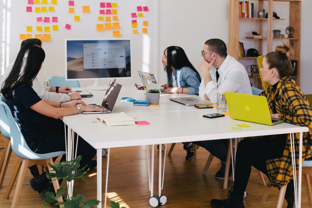 A team of professionals in a conference room practice effective communication skills. 